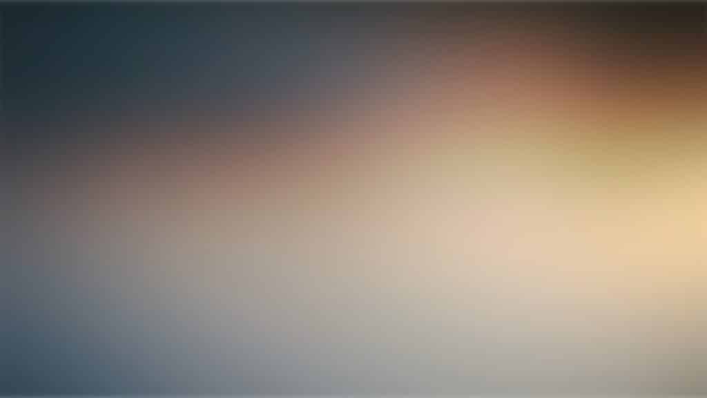 Soft gradient background blending dark blue to warm peach and pale yellow with a smooth blur.